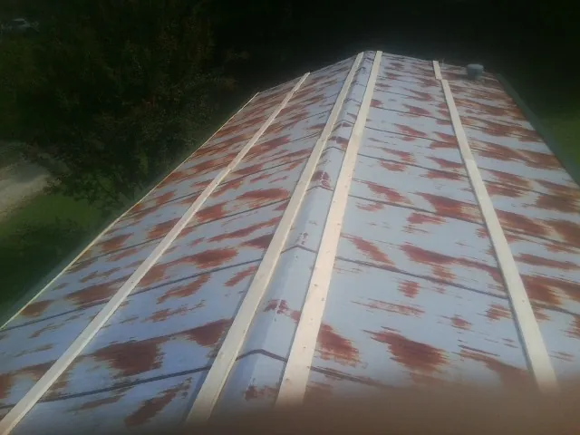 Rusted metal roof panels with new wood purlins before replacement — Storm Damage Roof Repair in Shawsville by Roofing Brothers