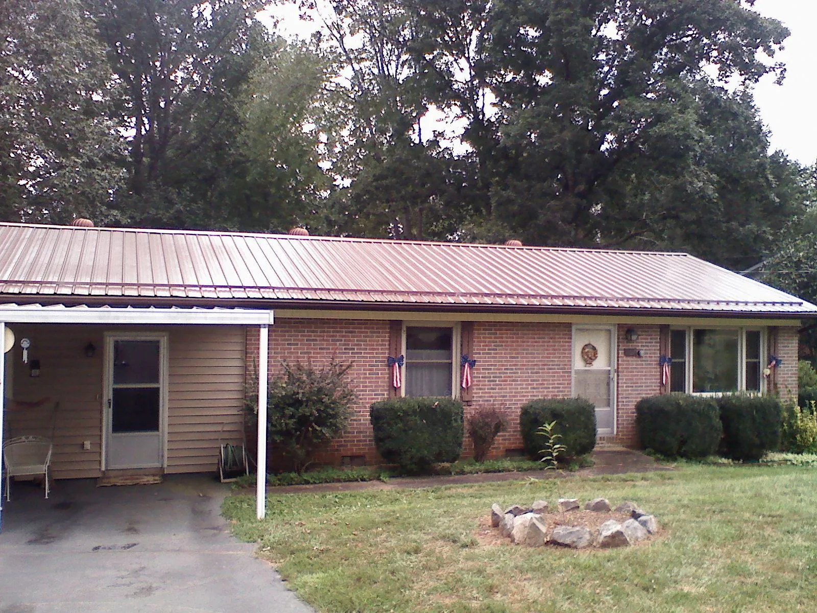 Bronze metal roof and carport on a brick ranch home — Roof Repair work by our crew in Shawsville