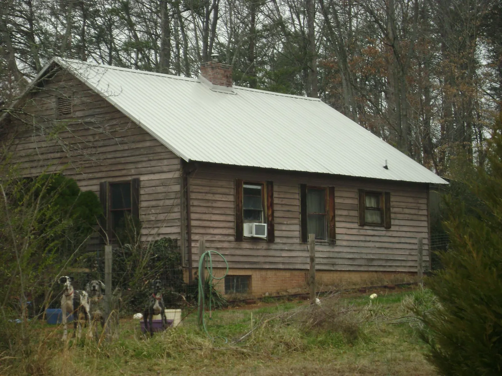White metal roof on an old wood sided farmhouse, from a Metal Roof Installation job in Shawsville